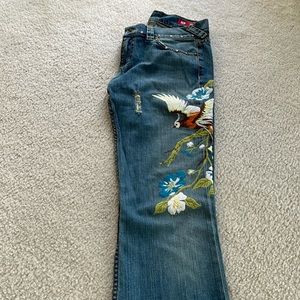 Embroidered jeans with grommet detail